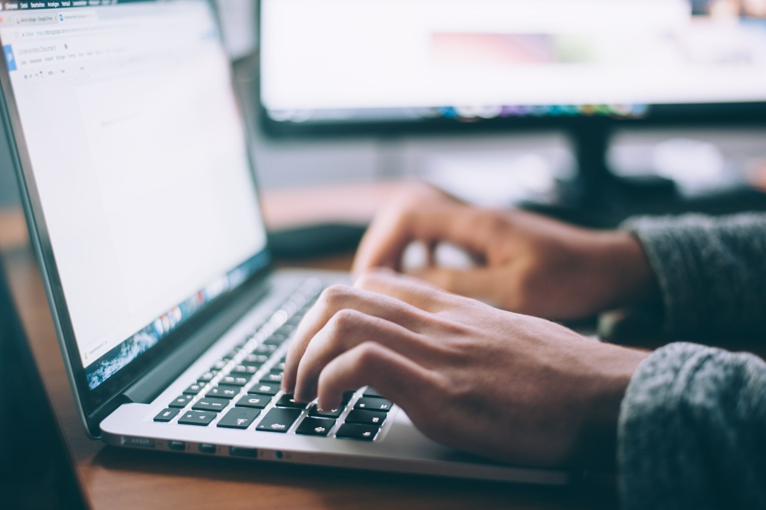 Image of a man typing on a laptop - Destination Certification