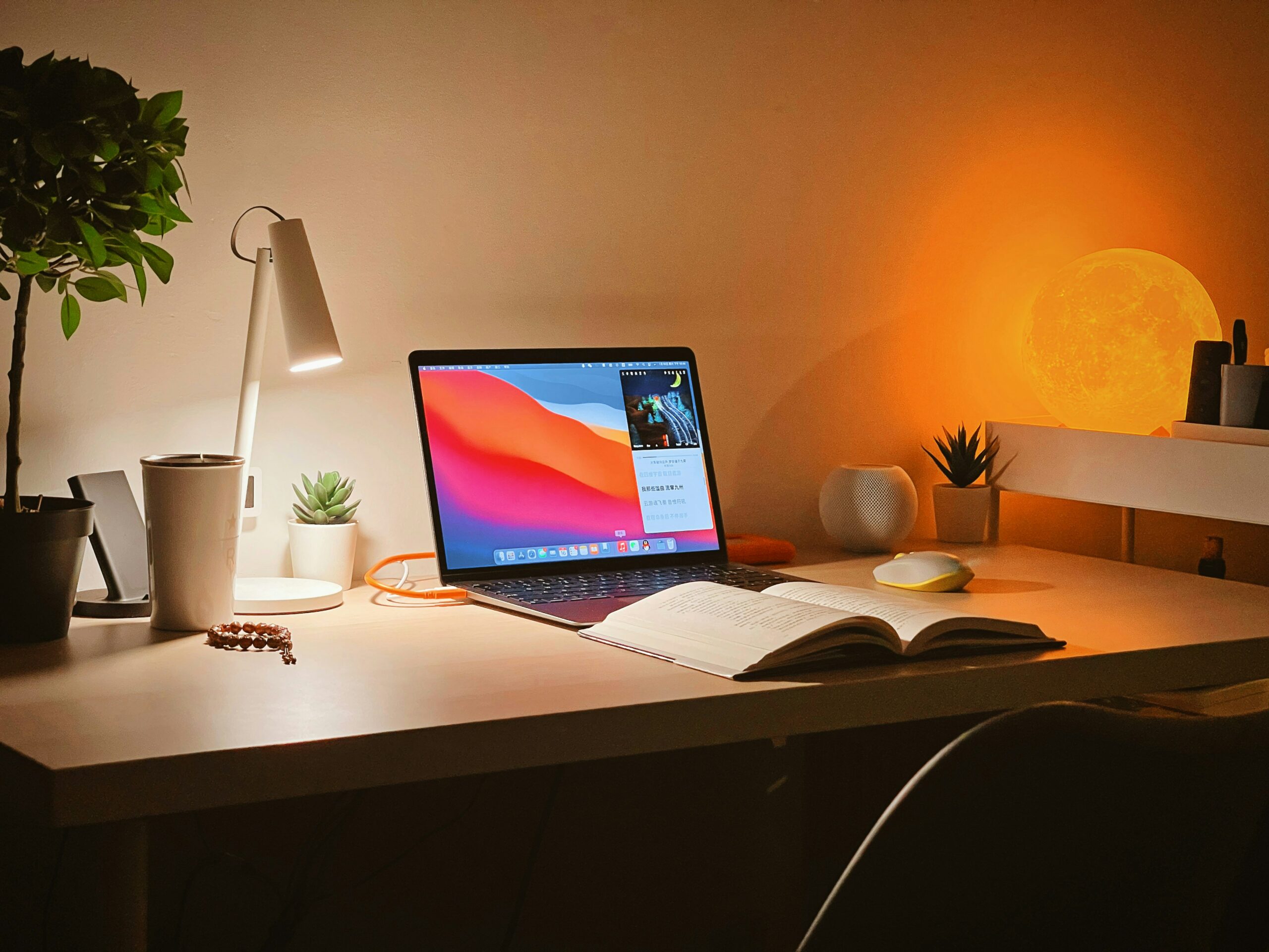Image of a dimmed room with laptop and book on the desk table - Destination Certification